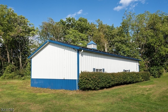 view of outbuilding featuring a yard