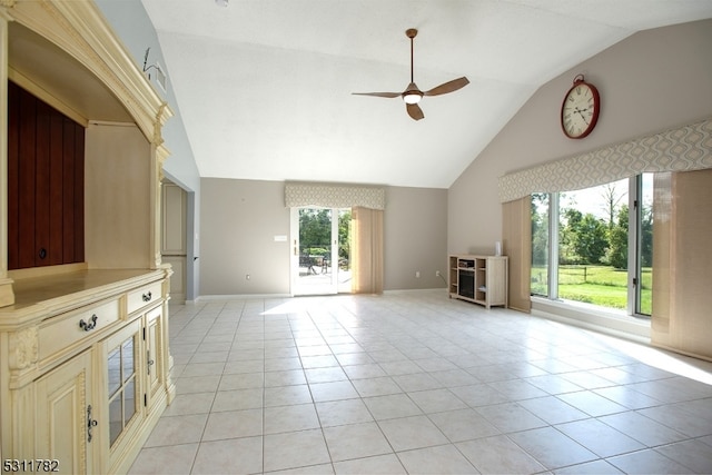 unfurnished living room with ceiling fan, light tile patterned flooring, and high vaulted ceiling