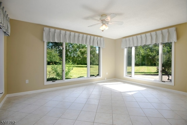 unfurnished room featuring ceiling fan and light tile patterned flooring