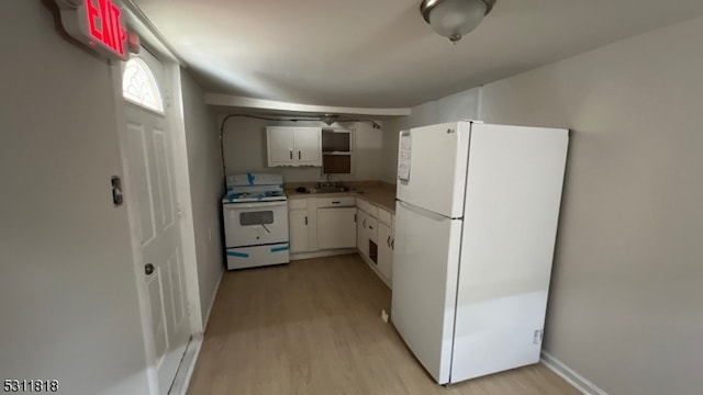 kitchen featuring white appliances, sink, white cabinets, and light hardwood / wood-style floors