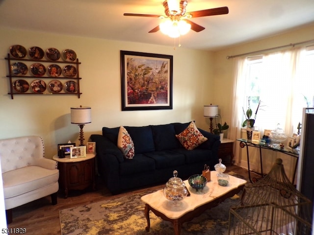 living room with dark wood-type flooring and ceiling fan