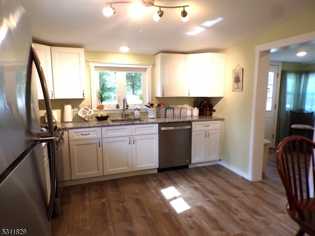 kitchen featuring appliances with stainless steel finishes, white cabinetry, and sink