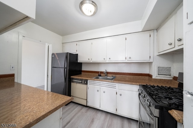 kitchen with light wood-type flooring, white cabinetry, appliances with stainless steel finishes, and sink