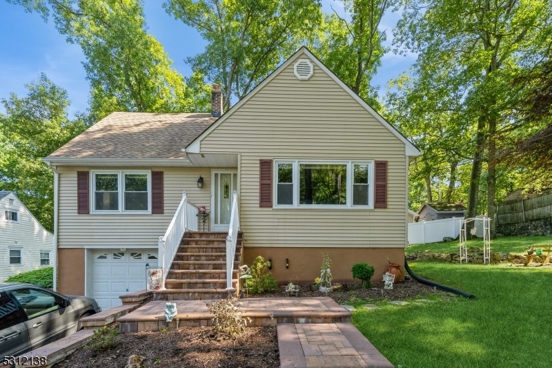 view of front of home with a garage and a front yard