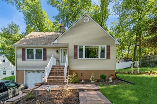 view of front of home with a garage and a front yard