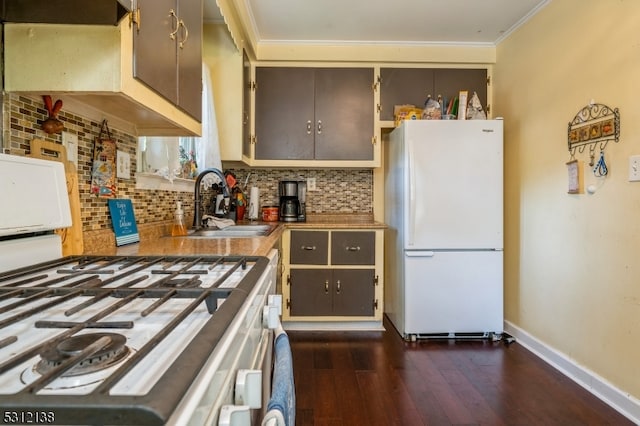 kitchen featuring crown molding, white appliances, backsplash, sink, and dark hardwood / wood-style floors