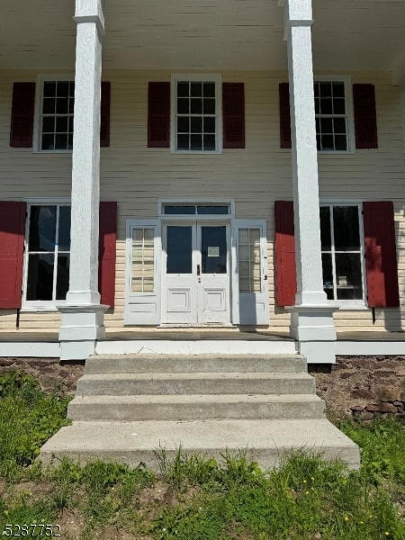 doorway to property featuring a porch