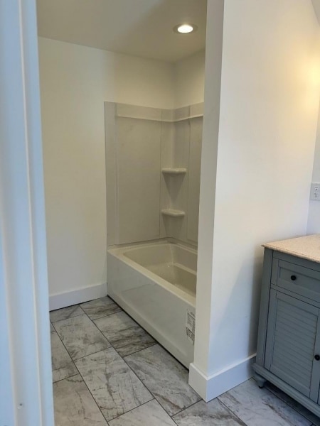 bathroom featuring vanity and washtub / shower combination