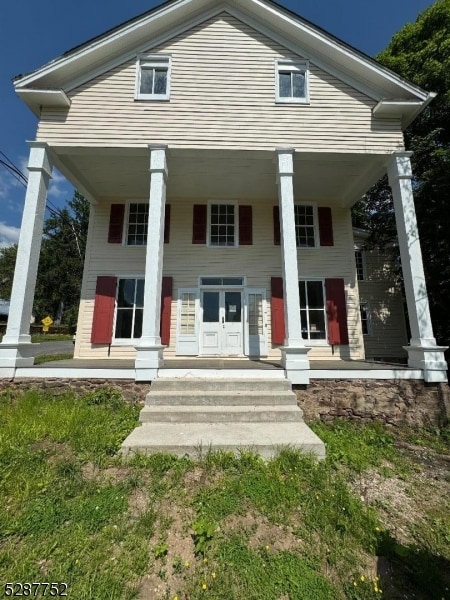 rear view of property with a porch