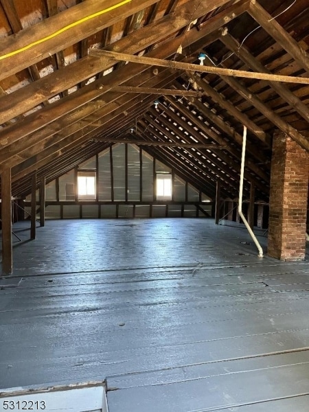 unfinished attic featuring plenty of natural light