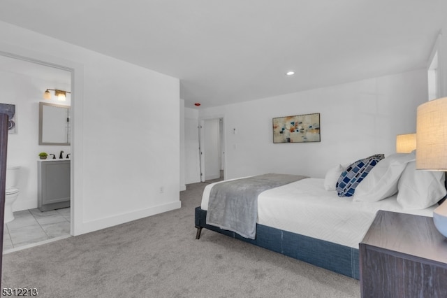 carpeted bedroom with ensuite bathroom