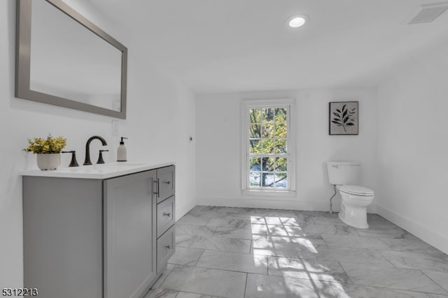 bathroom featuring vanity and toilet