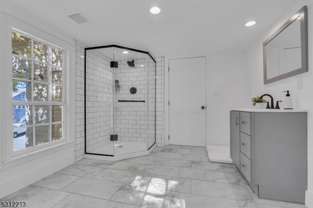 bathroom featuring vanity and a shower with shower door