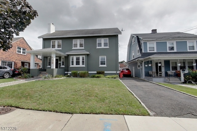 view of front of home with a front lawn and covered porch