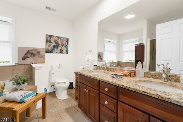 bathroom with vanity, tile patterned floors, and toilet