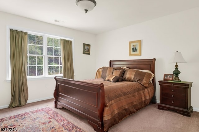 bedroom featuring light colored carpet