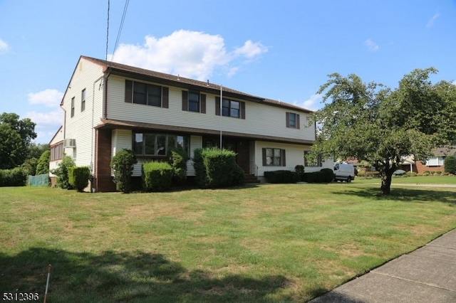 view of property featuring a front lawn