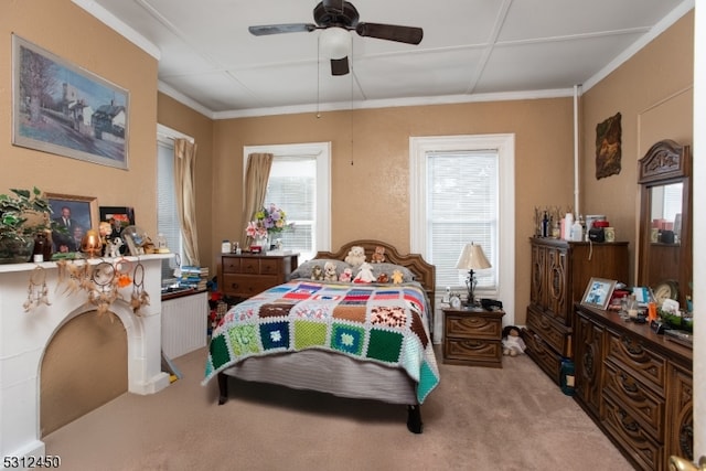 bedroom featuring ceiling fan, light colored carpet, and ornamental molding