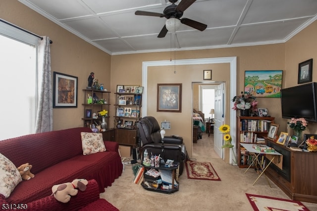 living room featuring light colored carpet, plenty of natural light, ornamental molding, and ceiling fan