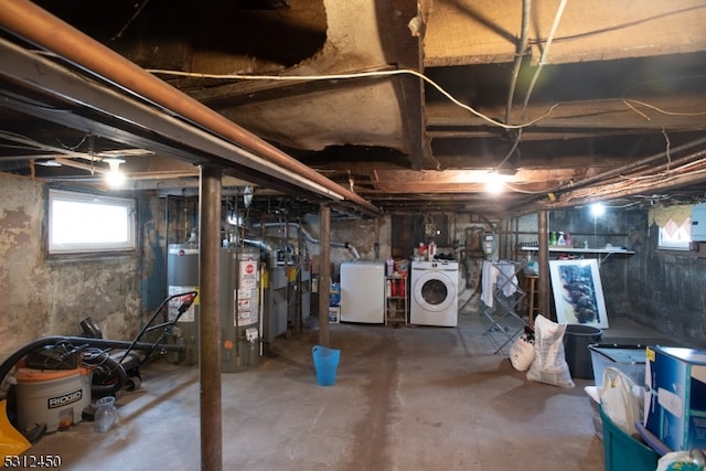 basement with washer and clothes dryer and water heater