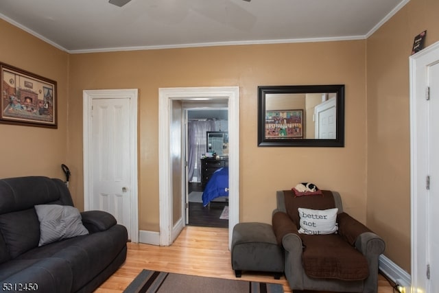 living room with light wood-type flooring and crown molding