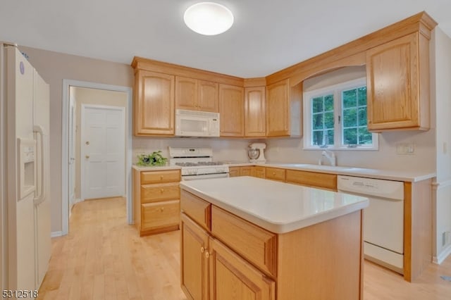 kitchen with a kitchen island, white appliances, light hardwood / wood-style floors, sink, and light brown cabinets