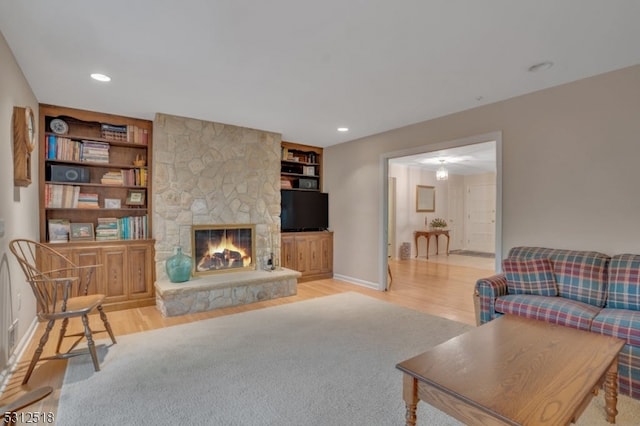 living room featuring light hardwood / wood-style flooring and a fireplace