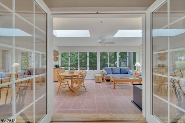 sunroom featuring a skylight and ceiling fan