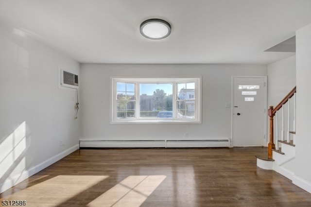 foyer entrance featuring dark hardwood / wood-style floors, a wall mounted air conditioner, and a baseboard heating unit