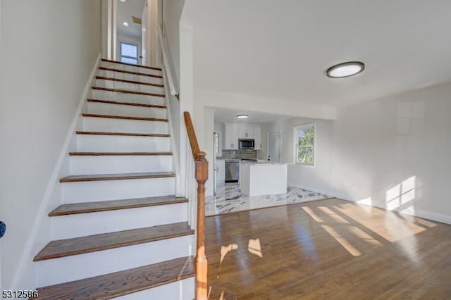 stairs featuring hardwood / wood-style flooring