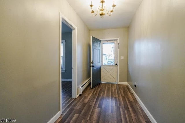 doorway to outside with an inviting chandelier, a baseboard radiator, and dark hardwood / wood-style floors