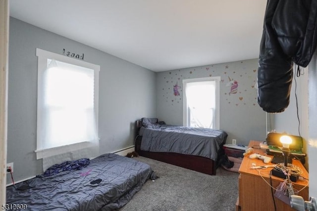 carpeted bedroom featuring a baseboard heating unit