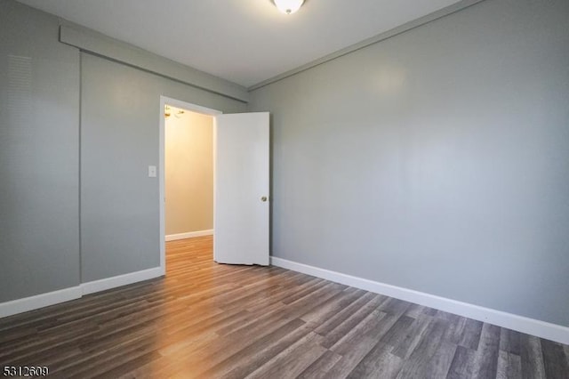 spare room with hardwood / wood-style flooring