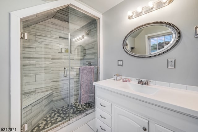 bathroom featuring walk in shower, vanity, and tile patterned flooring