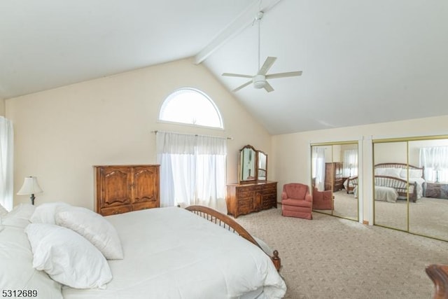 carpeted bedroom with ceiling fan, high vaulted ceiling, multiple closets, and beam ceiling