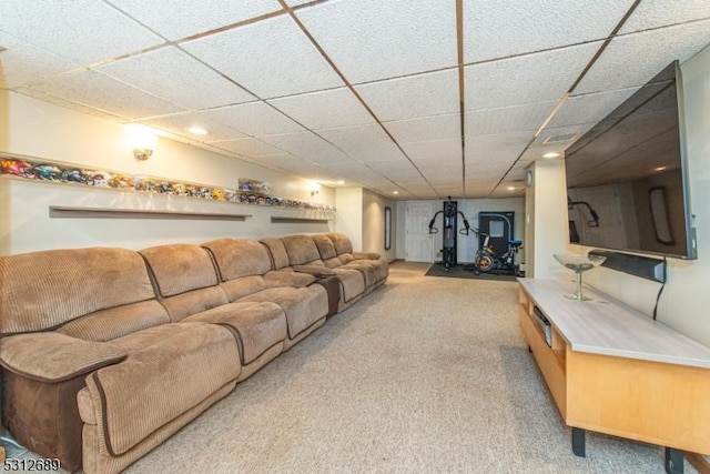 living room featuring light carpet and a drop ceiling