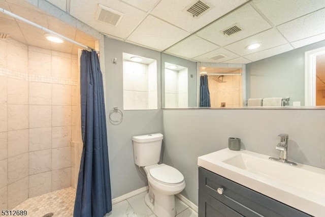 bathroom featuring toilet, vanity, a paneled ceiling, and curtained shower