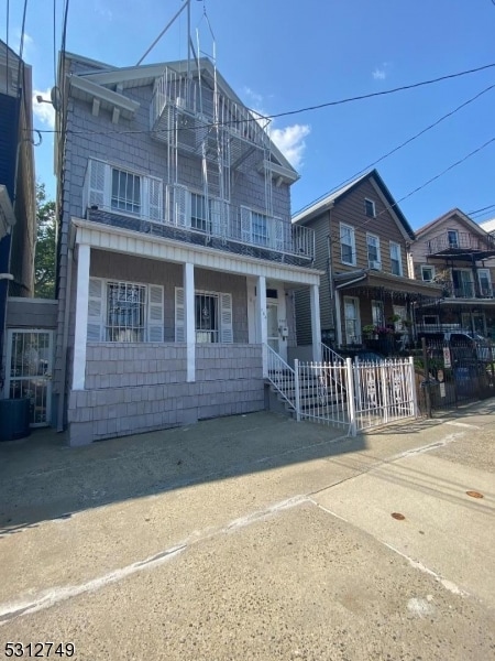 view of front of property with a balcony and covered porch