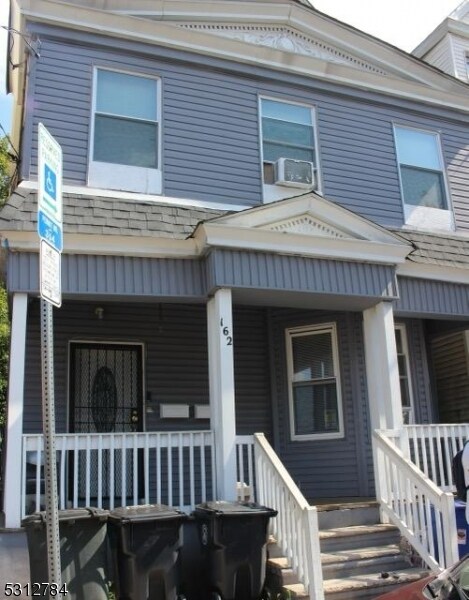 view of front facade featuring cooling unit and a porch