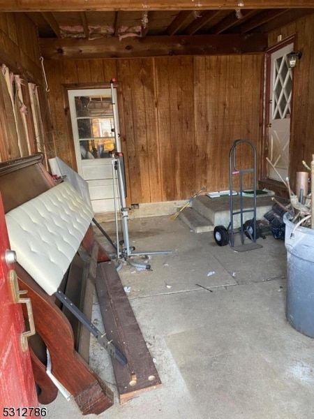 basement featuring wooden walls