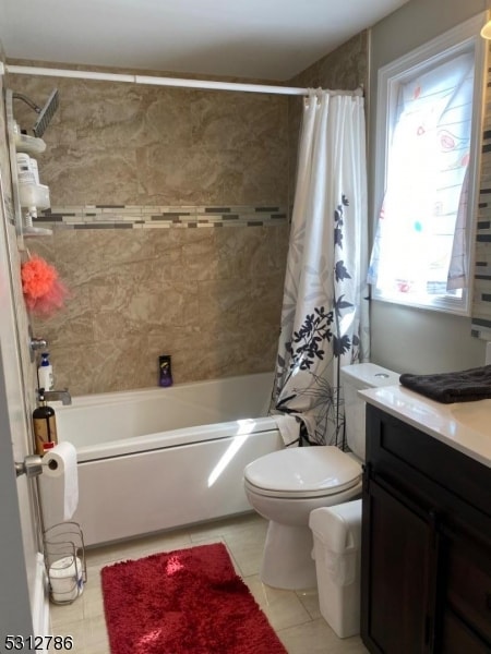 full bathroom featuring vanity, shower / tub combo, toilet, and tile patterned flooring