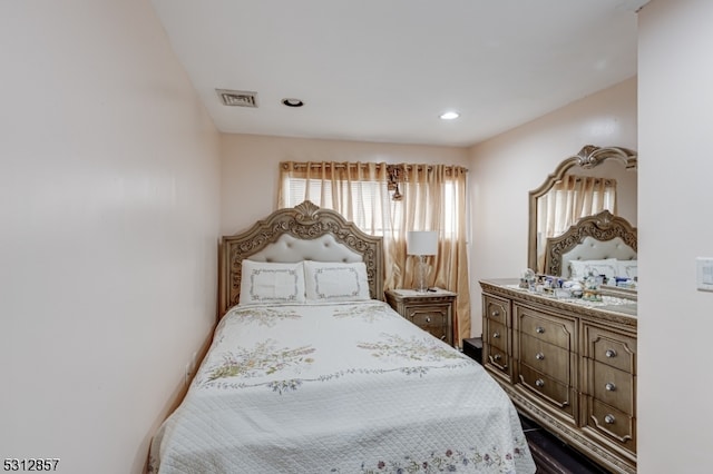 bedroom with hardwood / wood-style flooring