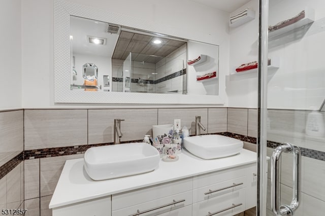 bathroom featuring tile walls, vanity, and a shower with door