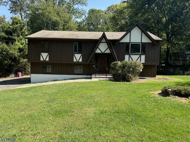 tudor-style house featuring a front lawn