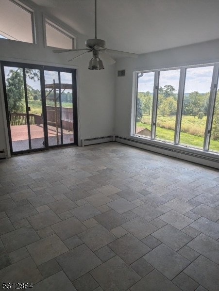 empty room featuring baseboard heating and ceiling fan