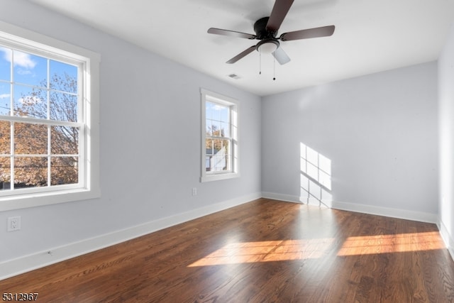 empty room featuring dark hardwood / wood-style floors and ceiling fan