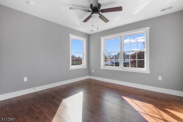 spare room featuring dark hardwood / wood-style flooring and ceiling fan