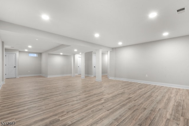 basement with light hardwood / wood-style flooring