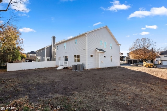 rear view of property with central AC