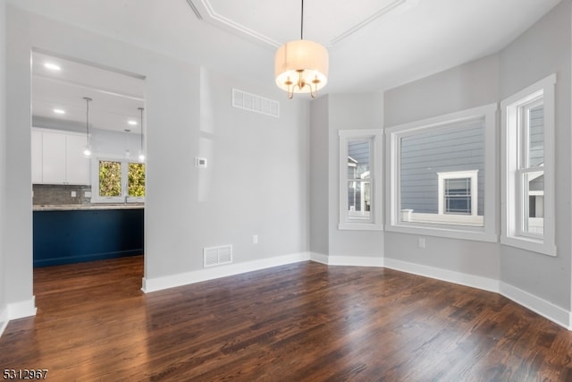 interior space with dark wood-type flooring and a notable chandelier